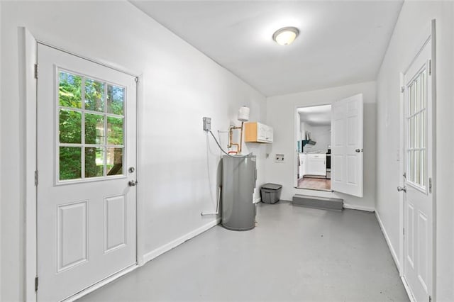 doorway featuring finished concrete floors and baseboards