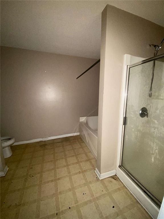 bathroom with toilet and shower with separate bathtub