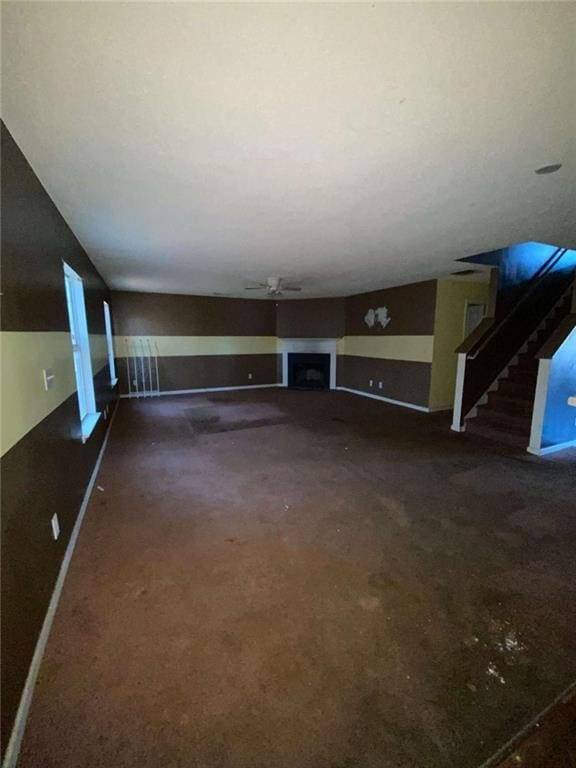 unfurnished living room with ceiling fan