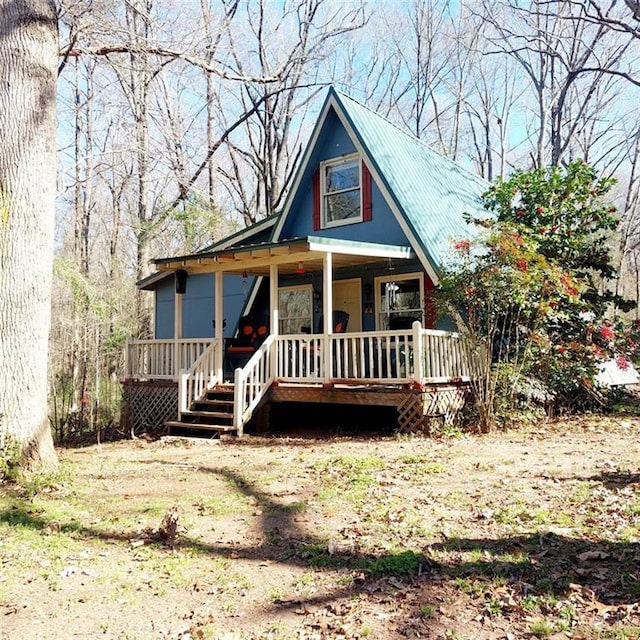 view of front facade with covered porch and metal roof