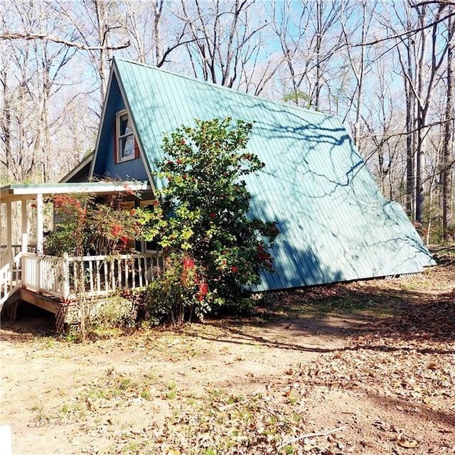 view of property exterior featuring metal roof