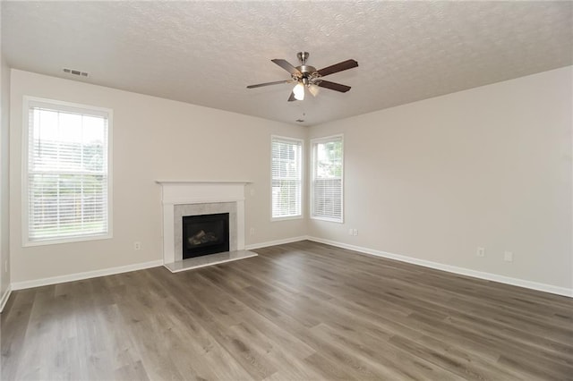 194 Wilhelmina Dr, Austell, GA 30168 - unfurnished living room featuring a textured ceiling, wood finished floors, a ceiling fan, and baseboards