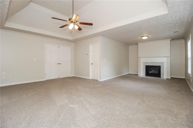 194 Wilhelmina Dr, Austell, GA 30168 - unfurnished living room featuring a tray ceiling, a ceiling fan, carpet, a premium fireplace, and a textured ceiling