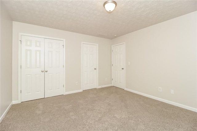 194 Wilhelmina Dr, Austell, GA 30168 - unfurnished bedroom with carpet flooring, a textured ceiling, baseboards, and a closet