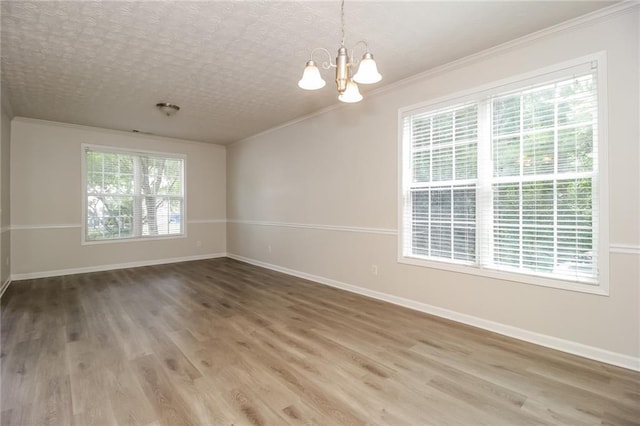 194 Wilhelmina Dr, Austell, GA 30168 - spare room with ornamental molding, a chandelier, baseboards, and wood finished floors