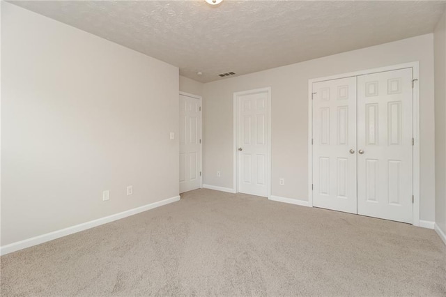 194 Wilhelmina Dr, Austell, GA 30168 - unfurnished bedroom featuring carpet floors, baseboards, a closet, and a textured ceiling
