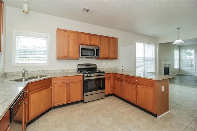 194 Wilhelmina Dr, Austell, GA 30168 - kitchen with stainless steel appliances, a sink, a peninsula, and brown cabinetry