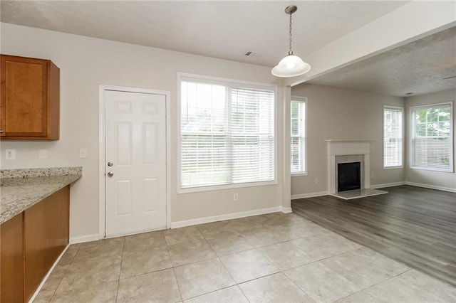 194 Wilhelmina Dr, Austell, GA 30168 - unfurnished living room featuring baseboards, light tile patterned floors, and a premium fireplace