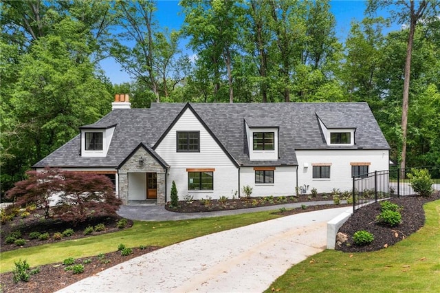 view of front of house with fence, a front lawn, and stone siding