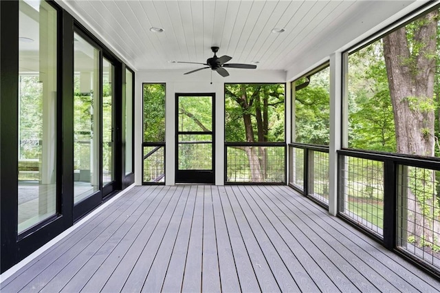 unfurnished sunroom featuring ceiling fan and a healthy amount of sunlight