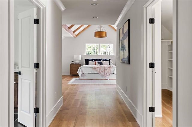 corridor featuring baseboards, light wood-type flooring, and recessed lighting