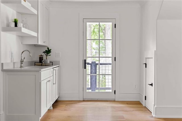 entryway featuring a sink and light wood-style flooring