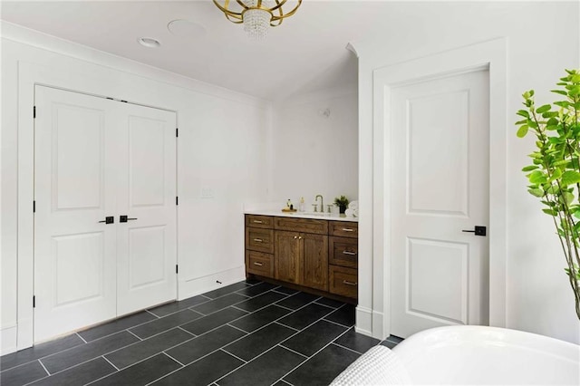 bathroom featuring a soaking tub, tile patterned floors, and vanity