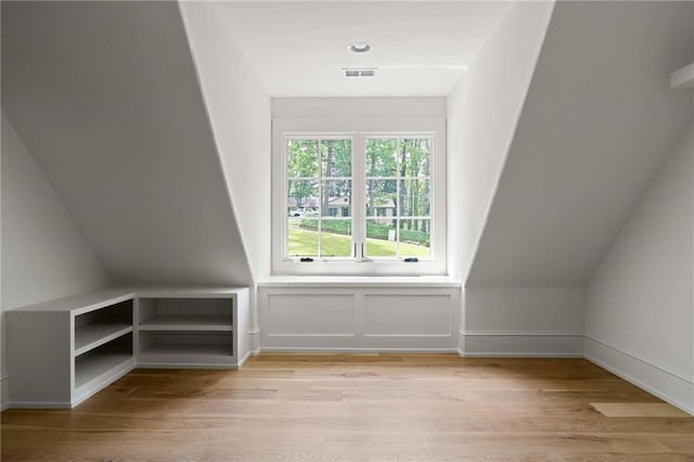 bonus room with visible vents and light wood-style floors