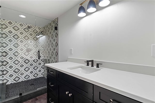full bathroom featuring vanity and a tile shower