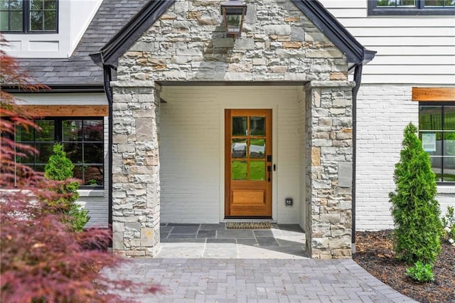 view of exterior entry featuring stone siding