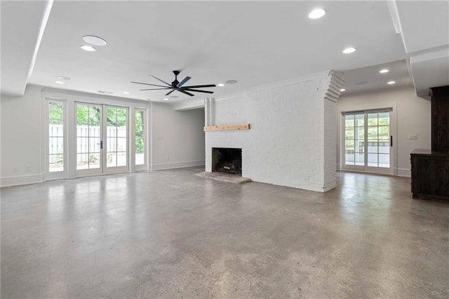 unfurnished living room with finished concrete floors, a fireplace, a ceiling fan, and recessed lighting