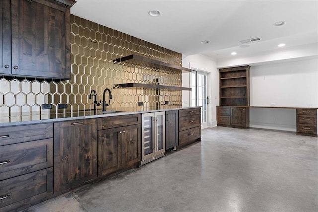 bar featuring concrete floors, beverage cooler, indoor wet bar, decorative backsplash, and recessed lighting