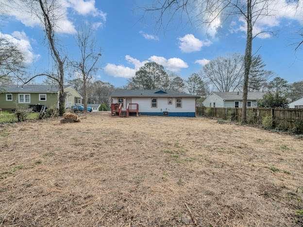 rear view of house with fence