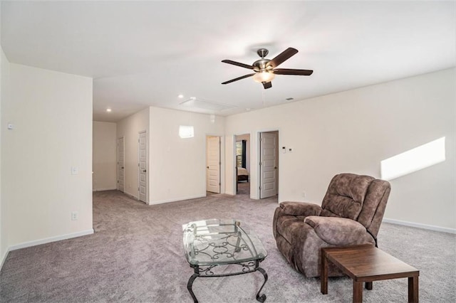 living area featuring ceiling fan and light colored carpet