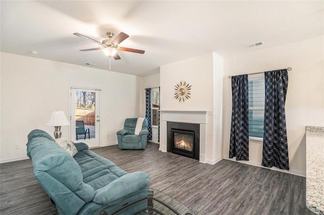 living room with ceiling fan and dark hardwood / wood-style flooring