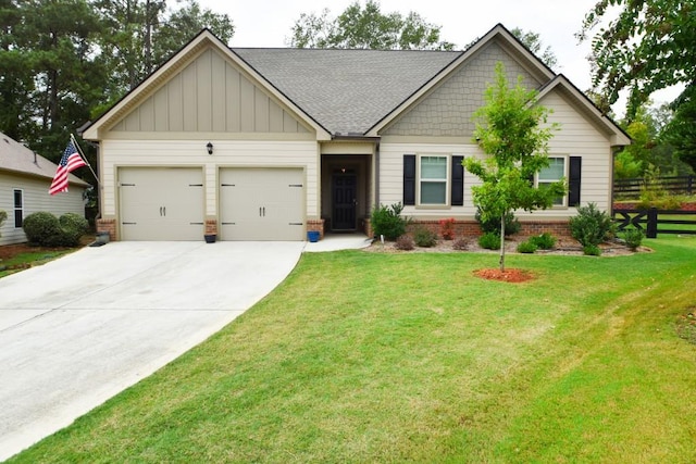 craftsman house with a front yard and a garage