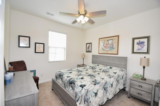 bedroom with ceiling fan and light colored carpet