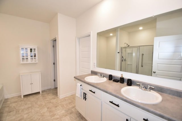 bathroom with vanity and a shower with door