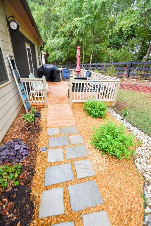 view of patio / terrace with a wooden deck and a grill