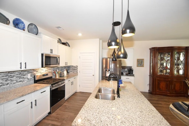 kitchen with white cabinets, stainless steel appliances, dark wood-type flooring, and sink