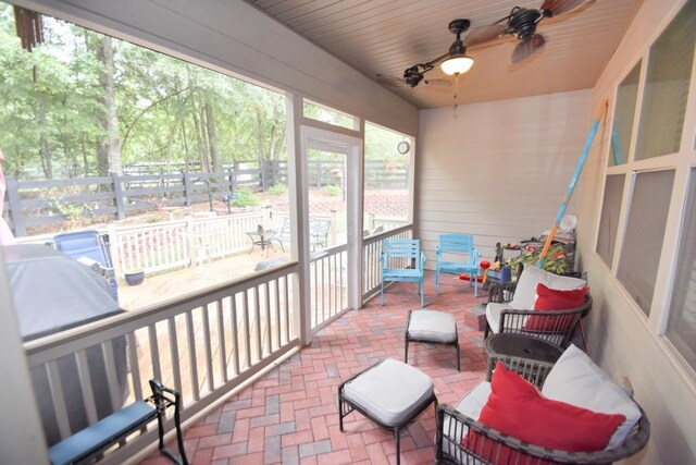 sunroom featuring wooden ceiling and ceiling fan