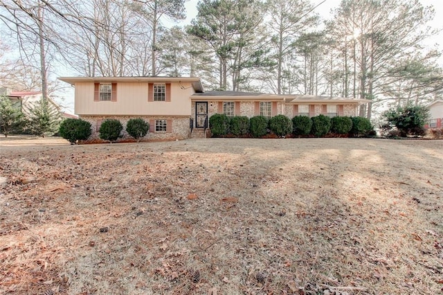 split level home featuring brick siding