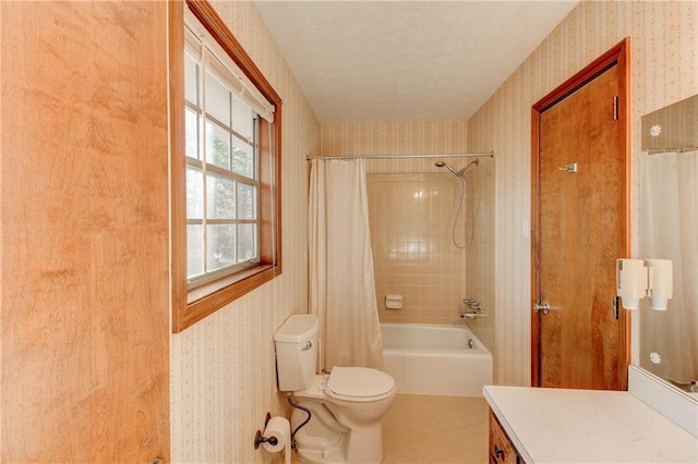 bathroom featuring toilet, wallpapered walls, shower / bath combination with curtain, and vanity