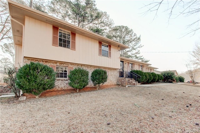 view of side of home featuring brick siding