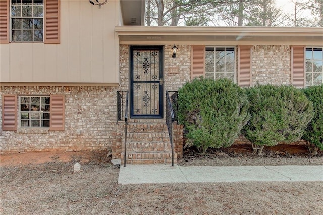 doorway to property featuring brick siding