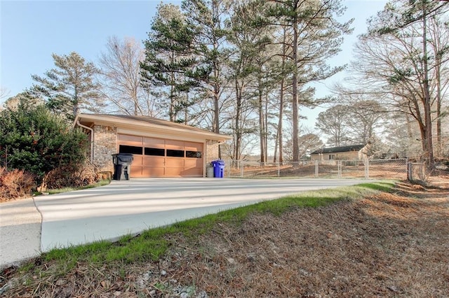 view of home's community with a garage, an outbuilding, and fence