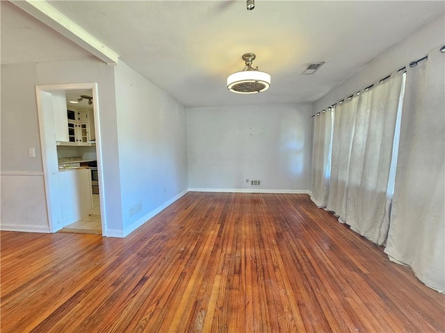 spare room featuring hardwood / wood-style floors