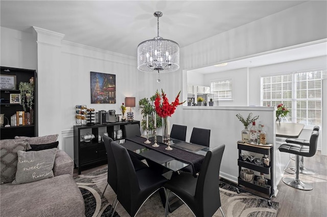 dining room with a notable chandelier and wood finished floors