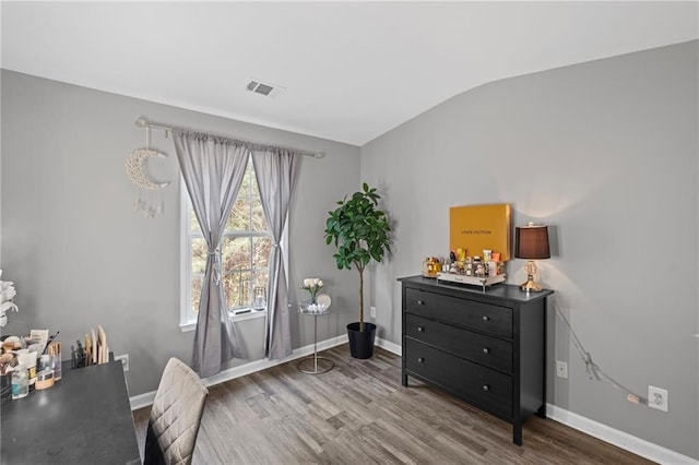 office area featuring visible vents, baseboards, and wood finished floors
