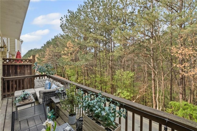 balcony with a forest view and an outdoor living space
