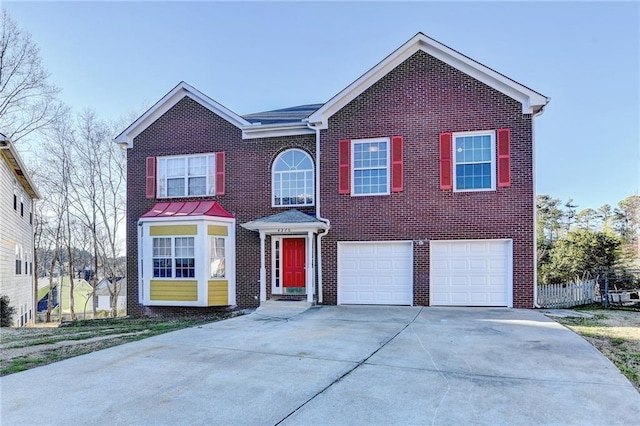 view of front of home featuring a garage, driveway, and brick siding