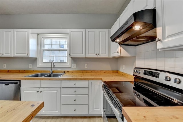 kitchen featuring under cabinet range hood, butcher block counters, and stainless steel appliances