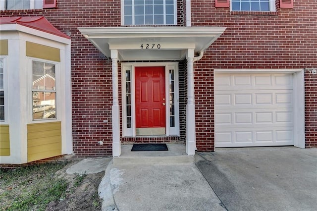 doorway to property with brick siding