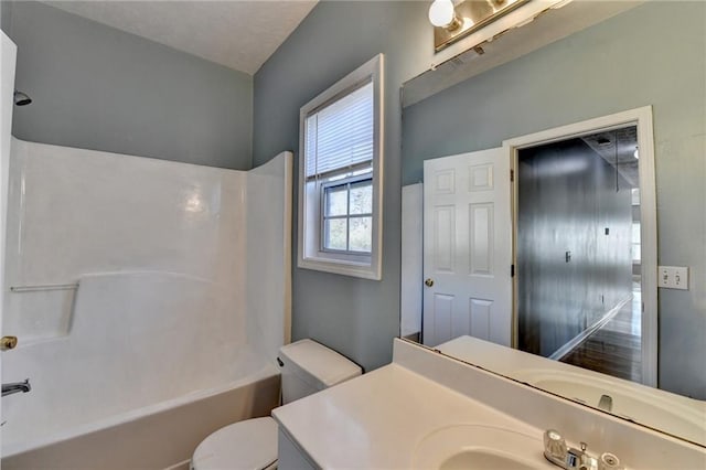 bathroom featuring shower / washtub combination, vanity, and toilet