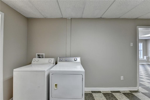 laundry room featuring laundry area, dark floors, baseboards, and washing machine and clothes dryer