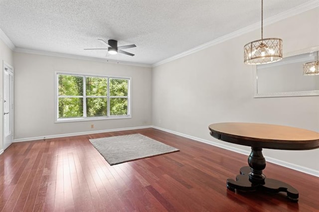 unfurnished room with crown molding, dark wood-type flooring, and a textured ceiling