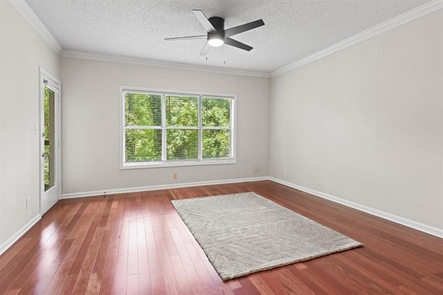 spare room featuring a textured ceiling, dark hardwood / wood-style floors, ceiling fan, and crown molding