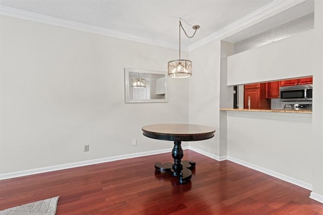 unfurnished dining area with dark hardwood / wood-style flooring, an inviting chandelier, a textured ceiling, and ornamental molding