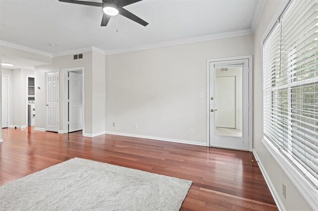 empty room with dark hardwood / wood-style flooring, ceiling fan, and crown molding