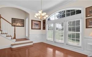 interior space featuring hardwood / wood-style floors and a notable chandelier